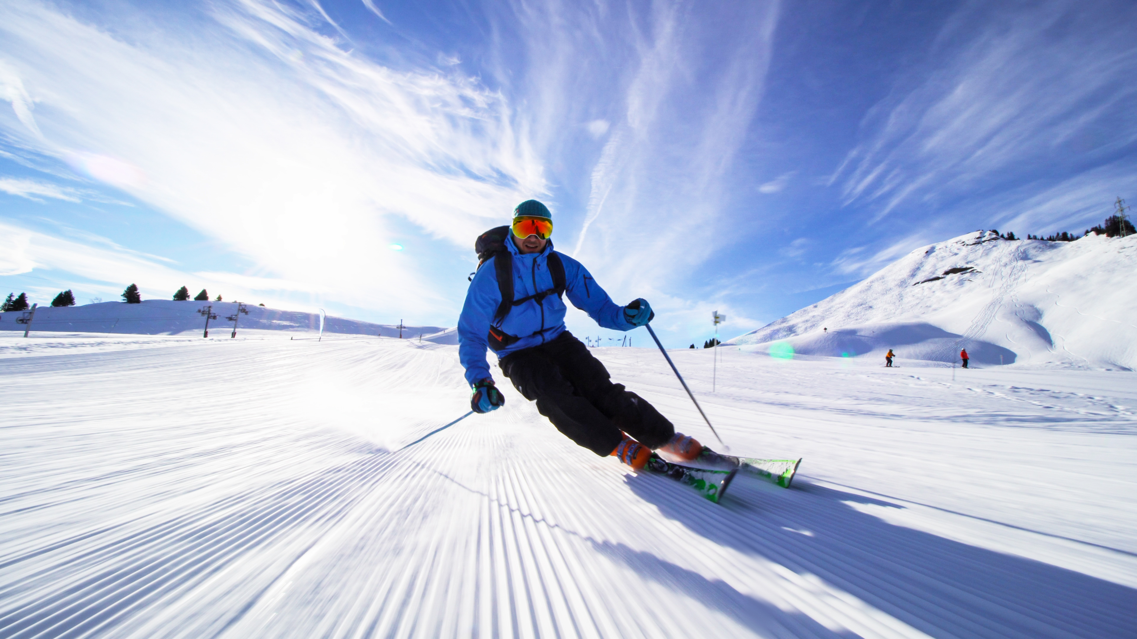 Skier carving on a freshly groomed piste