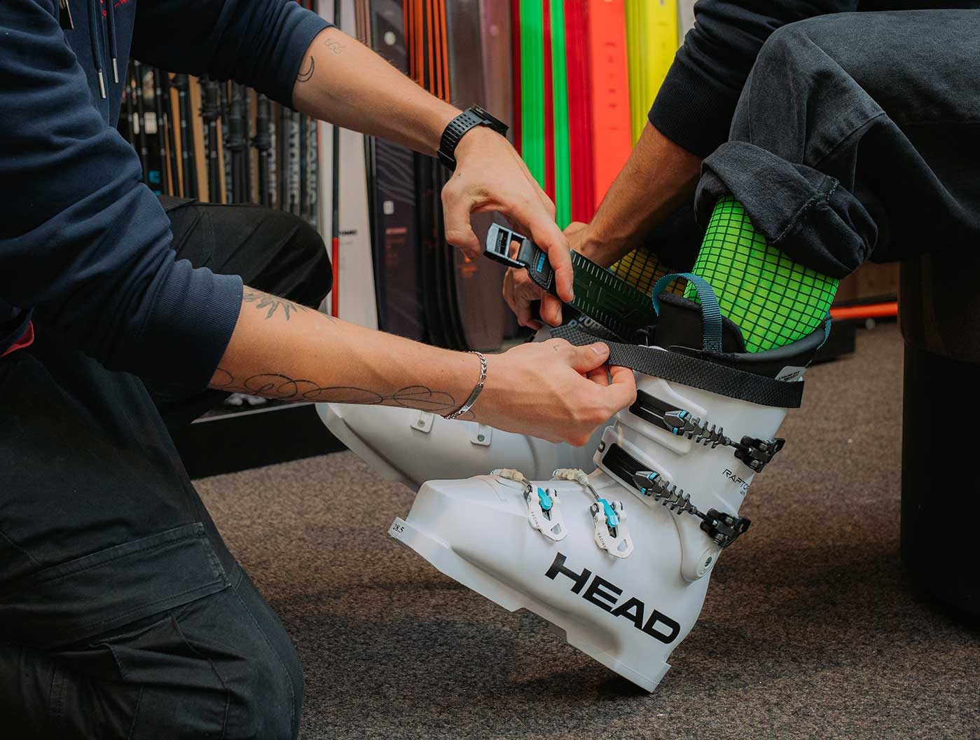 Boot fitter adjusting a Head ski boot on a customer