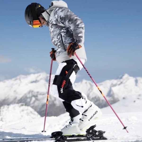 Ski Mojo dynamic knee-support brace worn over ski boots